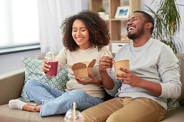 Image showing happy couple with takeaway food and drinks at home