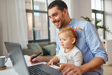 Image showing working father with baby daughter at home office
