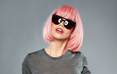 Image showing happy woman in pink wig and black sunglasses