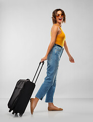Image showing happy young woman in sunglasses with travel bag