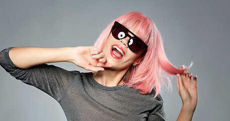 Image showing happy woman in pink wig and black sunglasses