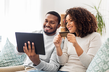 Image showing couple with tablet pc and credit card at home