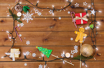 Image showing christmas gifts and decorations on wooden boards