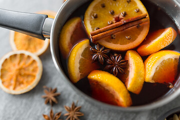 Image showing pot with hot mulled wine, orange slices and spices