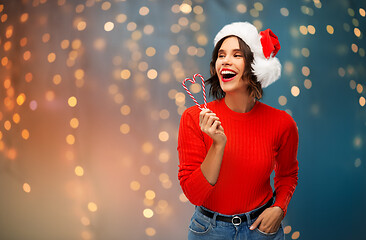 Image showing happy young woman in santa hat on christmas