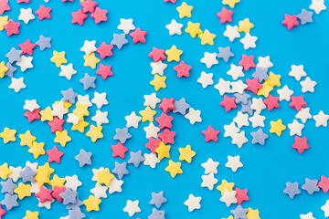 Image showing star shaped pastry sprinkles on blue background