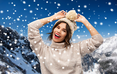 Image showing young woman in knitted winter hat in mountains