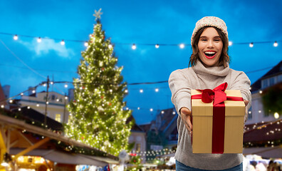 Image showing happy woman holding gift box at christmas market