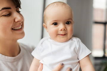 Image showing happy young mother holding little baby daughter