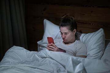 Image showing Smartphone usage in bed at night