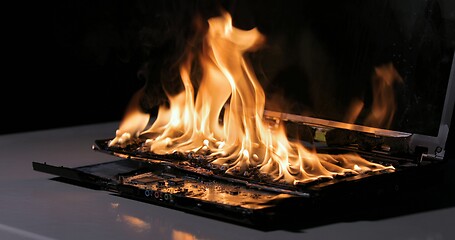 Image showing Burning laptop computer electronics closeup