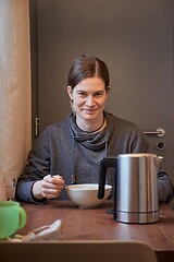 Image showing Woman eating breakfast bowl of cereals