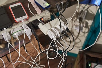 Image showing Charging phones and other devices in a mess