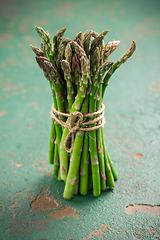 Image showing Green asparagus on old kitchen table