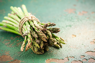 Image showing Green asparagus on old kitchen table