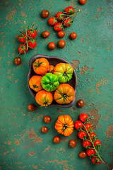 Image showing Assortment of organic tomatoes on old kitchen table