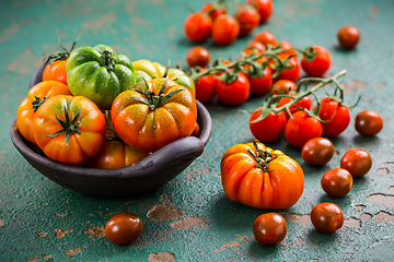 Image showing Assortment of organic tomatoes on old kitchen table