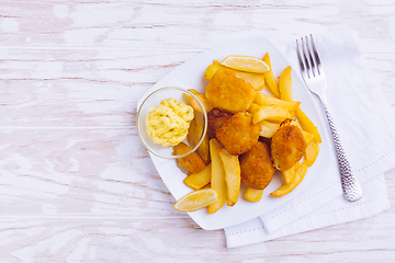 Image showing Fish and chips with dip on white plate