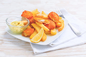 Image showing Fish and chips with dip on white plate