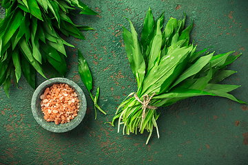 Image showing Bunch of Ramson or bear leek (Allium ursinum) with pink Himalayan salt on kitchen table