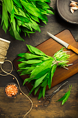 Image showing Bunch of Ramson or bear leek (Allium ursinum) with pink Himalayan salt on cutting board