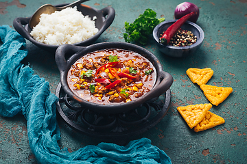 Image showing Hot Mexican Chili con carne with rice and tortilla chips and spices