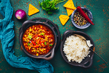 Image showing Hot Mexican Chili con carne with rice and tortilla chips and spices