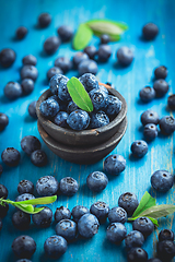 Image showing Organic blueberries on blue wooden background