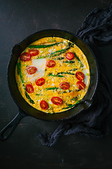 Image showing Delicious fritatta with green asparagus and cherry tomatoes