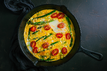 Image showing Delicious fritatta with green asparagus and cherry tomatoes