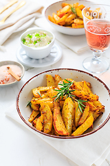 Image showing Homemade baked potato wedges with garlic dip