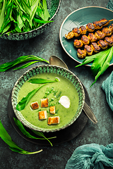 Image showing Bear leek soup or ramson soup with crouton, sour cream and turkey skewer