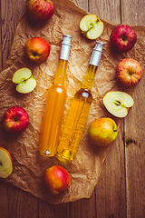 Image showing Apple juice with apple vinegar in bottles and fresh apples