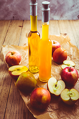 Image showing Apple juice with apple vinegar in bottles and fresh apples