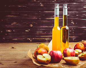 Image showing Apple juice with apple vinegar in bottles and fresh apples