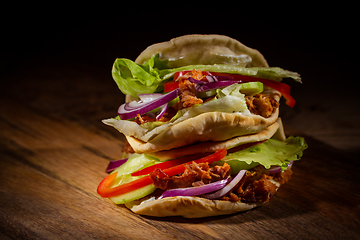 Image showing Homemade flatbread sandwich, kebab or doner with chicken meat, lettuce and vegetables