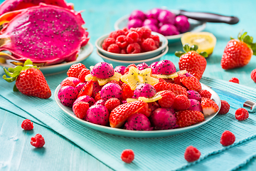 Image showing Fresh dragon fruit salad with strawberries, rspberries and start fruit (carambola)