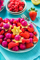 Image showing Fresh dragon fruit salad with strawberries, rspberries and start fruit (carambola)