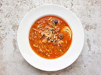 Image showing portion of tomato soup with sausage and olives