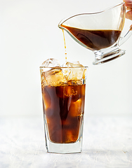 Image showing coffee pouring into glass of ice