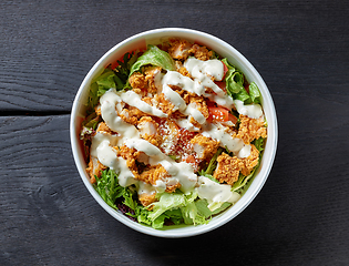 Image showing caesar salad on black wooden table