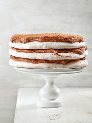 Image showing homemade meringue and nut cake with chocolate cream