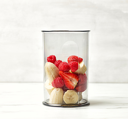 Image showing fresh banana pieces and red berries in plastic transparent blend