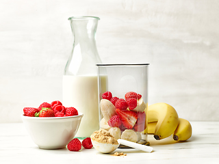 Image showing fresh banana pieces and red berries in plastic transparent blend