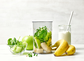 Image showing banana and various green vegetables in blender container