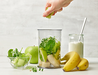 Image showing banana and various green vegetables in blender container