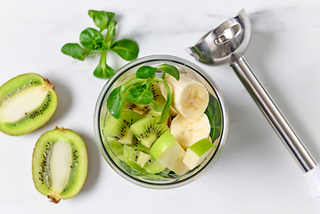 Image showing various fruit pieces in blender container