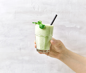 Image showing man's hand holds a smoothie glass