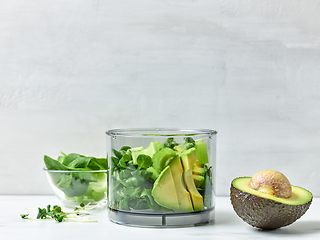 Image showing avocado, celery and spinach in plastic transparent blender conta