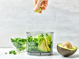 Image showing cook squeezing lime into blender container